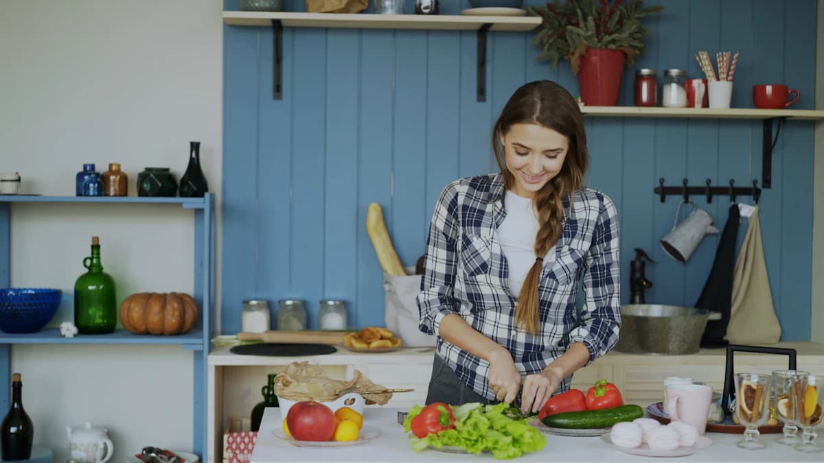 A woman preparing vegetables in her kitchen