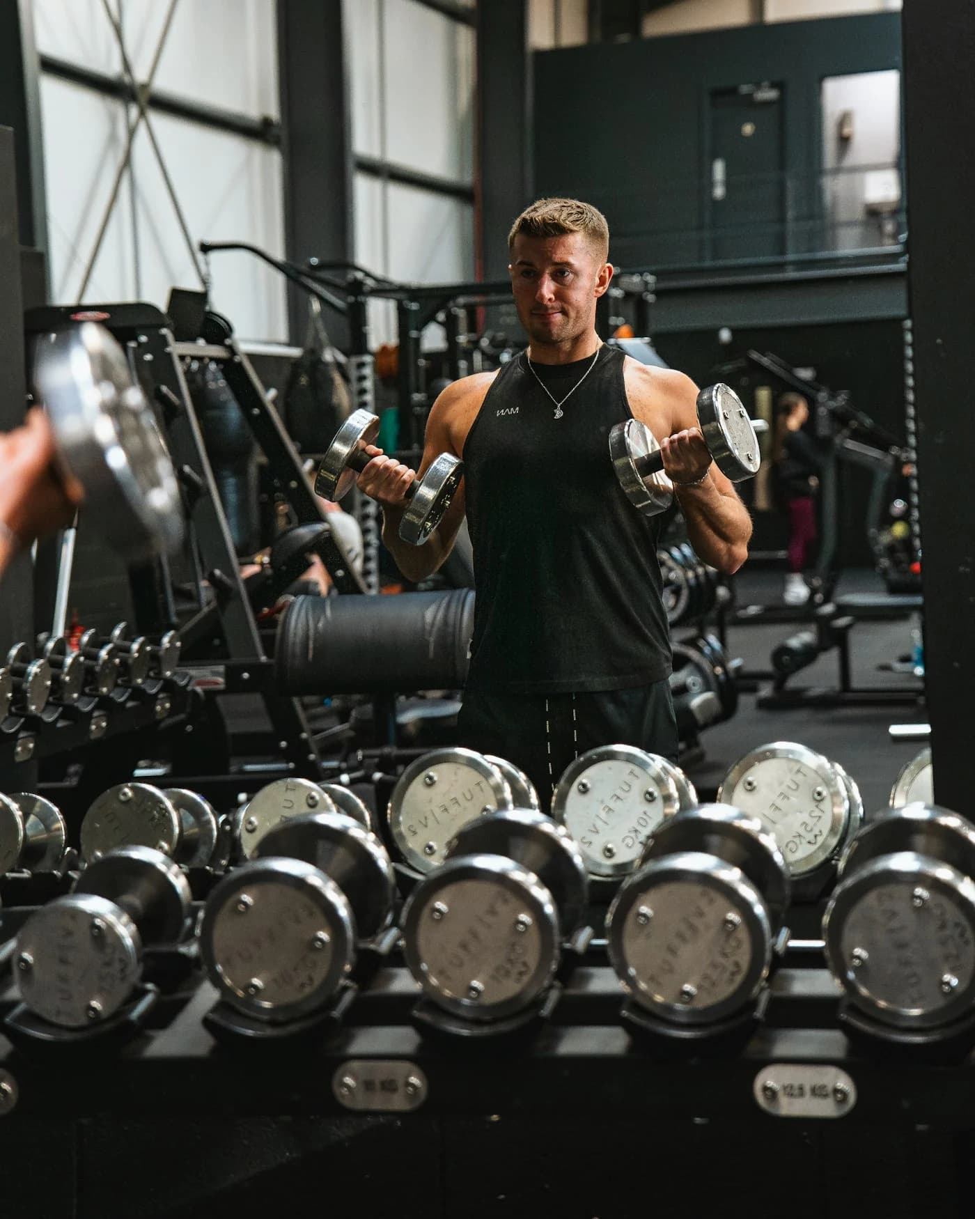 A man strength training, shown beside progress charts